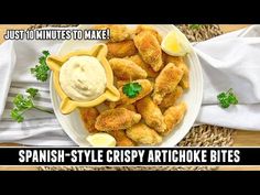 a white plate topped with fried food next to a napkin