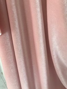 a close up view of a pink curtain