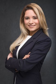 a woman in a business suit posing for a photo