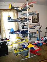 a room filled with assorted toy planes and toys on shelves next to a window