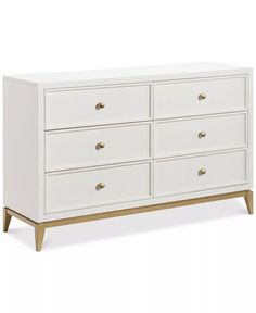 a white dresser with gold handles and drawers on the bottom, in front of a white background