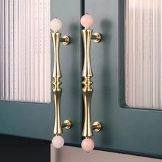 a pair of gold door handles on a blue front door with white bead trim