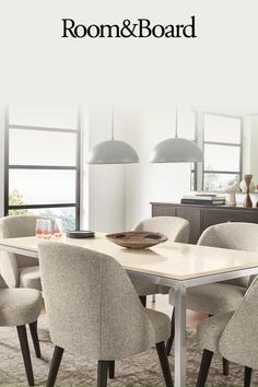 a dining room table and chairs with the words room & board above it