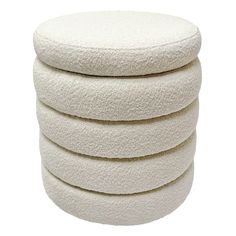 four white round cushions stacked on top of each other