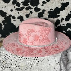 This beautiful traditional Rancher Hat has been burned, freehand style, with a compilation of flowers around the brim, crown and underside.  This would look great worn at a concert or just out and about.  This is a fun light pink color and is a size medium.  See size chart for more details. Western Pink Hat With Curved Brim, Western Style Pink Hat With Curved Brim, Pink Wide Brim Hat For Rodeo, Pink Brimmed Hat For Rodeo, Pink Curved Brim Hat For Rodeo, Pink Western Felt Hat With Curved Brim, Pink Western Style Felt Hat With Curved Brim, Pink Flat Brim Hat For Country Events, Fitted Pink Hat For Country Events