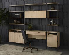 an office with black walls and wooden shelves on the wall, along with a leather chair