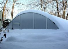 a car covered in snow next to a building