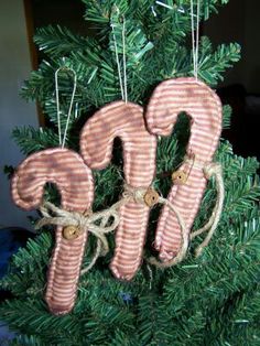 a christmas tree with ornaments hanging from it's branches in the shape of letters