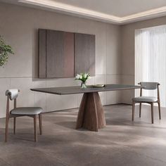 a dining room table with two chairs and a potted plant in the corner on the floor