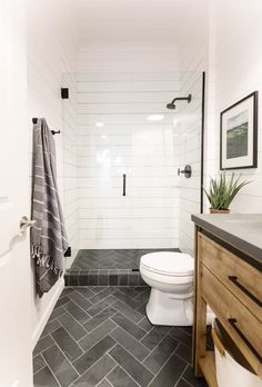 a white toilet sitting next to a walk in shower