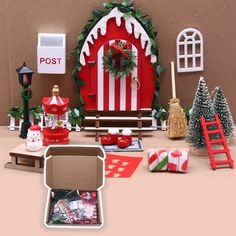 an assortment of christmas decorations and gifts on display in front of a post office decorated for the holiday season