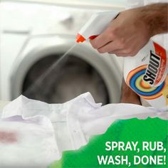 a person is washing clothes in front of a dryer