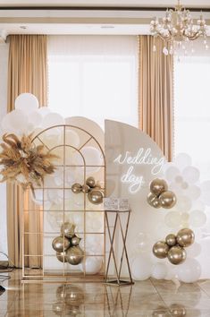 balloons and decorations are on display in front of a window with the word wedding day written on it