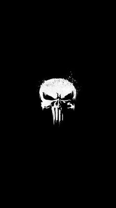 a black and white image of a skull on the side of a dark wallpaper