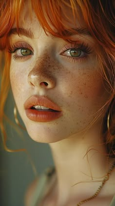 a woman with freckled hair and green eyes looks into the distance while wearing a necklace