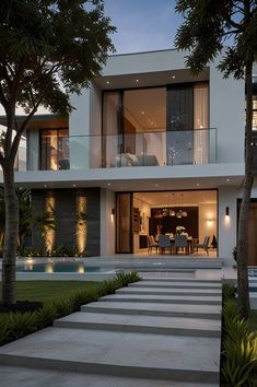 a modern house is lit up at night