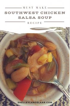 a white bowl filled with shrimp and vegetable soup on top of a blue table cloth