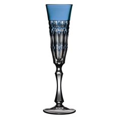 a tall blue glass with an intricate design on the rim and bottom, sitting in front of a white background