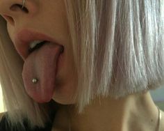 a woman with blonde hair sticking her tongue out