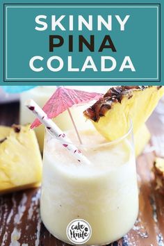 a pina cola drink in a glass with an umbrella on the top and pineapples behind it