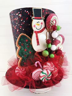 a christmas hat with candy canes, candies and a snowman on it