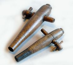 three wooden toy airplanes sitting on top of a white sheet