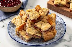 a pile of cranberry bars on a blue and white plate