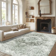 a living room filled with furniture and a fire place in front of a large window