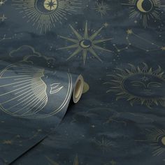 a blue and gold wallpaper with sun, moon and stars on it's surface