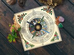 a wooden table topped with autumn leaves and a clock