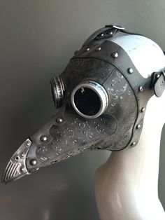 This black steampunk plague mask features striking red filigree details, riveted accents, and vintage-style goggles. Perfect for Halloween, masquerades, or steampunk-themed events, the intricate design blends gothic and industrial aesthetics, making it a standout costume accessory. The bold black finish with red embellishments ensures you'll capture attention at any event. Ideal for those seeking a dark and mysterious look. Age Group/Gender - Adult/Unisex Size/Type - One size fits all adults Mas Plague Costume, Plague Doctor Hat, Plague Doctor Halloween Costume, Steampunk Masquerade, Kids Party Packs, Mask For Halloween, Black Steampunk, Plague Mask, Dark And Mysterious