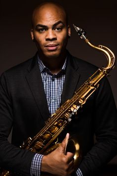 a man holding a saxophone in his hands