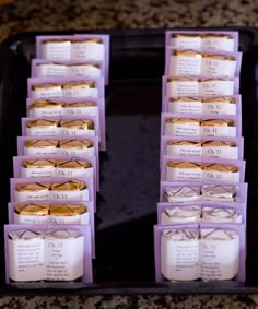 a tray filled with lots of small cookies on top of a table next to each other