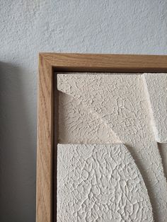 two pieces of white paper in a wooden frame