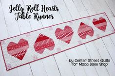 a table runner with hearts on it and the words jelly roll hearts table runner written in red