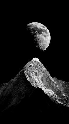 an image of two mountains with the moon in the sky