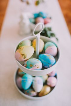 an easter egg tray with painted eggs in it and a spoon sticking out of the top