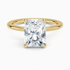 a princess cut diamond ring in yellow gold