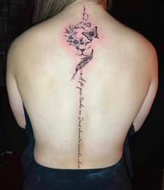 the back of a woman's neck with a tattoo on it