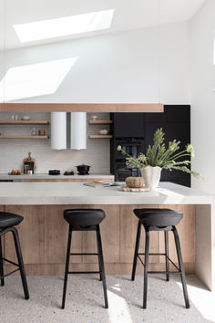 three stools are in front of the kitchen island