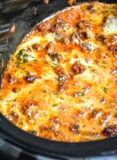 a close up of a casserole in a crock pot with broccoli and cheese