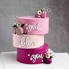 three tiered cake decorated with flowers and words