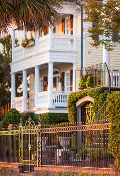 a large white house with an iron gate