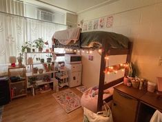 a dorm room with a bunk bed and desk