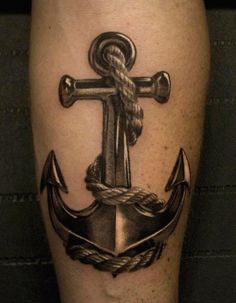 an anchor and rope tattoo on the leg is shown in black and grey colors,