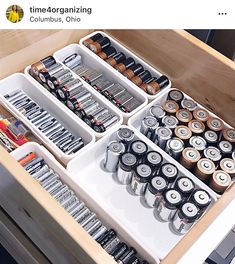 an open drawer filled with lots of different types of cans and batteries on it's sides