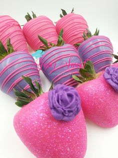 pink and purple chocolate covered strawberries on a white plate