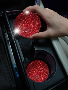 a person is holding onto a traffic light with red lights on it's sides