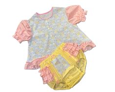 OVER THE MOON DIAPER Shirt Set will be custom made just for you. This little Diaper Shirt set is made from a very nice cotton blend fabrics. Little cows jumping over the moon with pink ruffles featuring yellow, blue and green moons and stars.  Neckline has pink piping and sleeves have matching ruffles and encased elastic.  This darling little diaper shirt snaps down the front. Diaper Cover is pale yellow with matching pink moon/stars.  Ruffles wrap around the hips and are topped with dainty satin bows.  All elastic is encased. Maximum shirt length 26" 🎀  🌼  🌷  🎈  🎀  🌼  🌷  🎈  🎀  🌼   Actual fabric color, lace, and trims may vary slightly from picture. I do my best to recreate this to the original picture. 🎀  🌼  🌷  🎈  🎀  🌼  🌷  🎈  🎀  🌼   🌷  MEASUREMENTS 🌷 maximum size lis Diaper Shirt, Moons And Stars, Green Moon, Pink Moon, Pink Ruffle, Moon Stars, Diaper Cover, Over The Moon, Pale Yellow