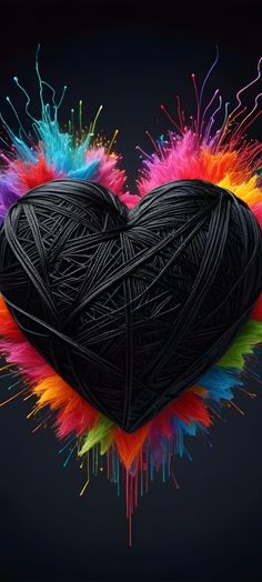 a heart - shaped object with multicolored yarn on it